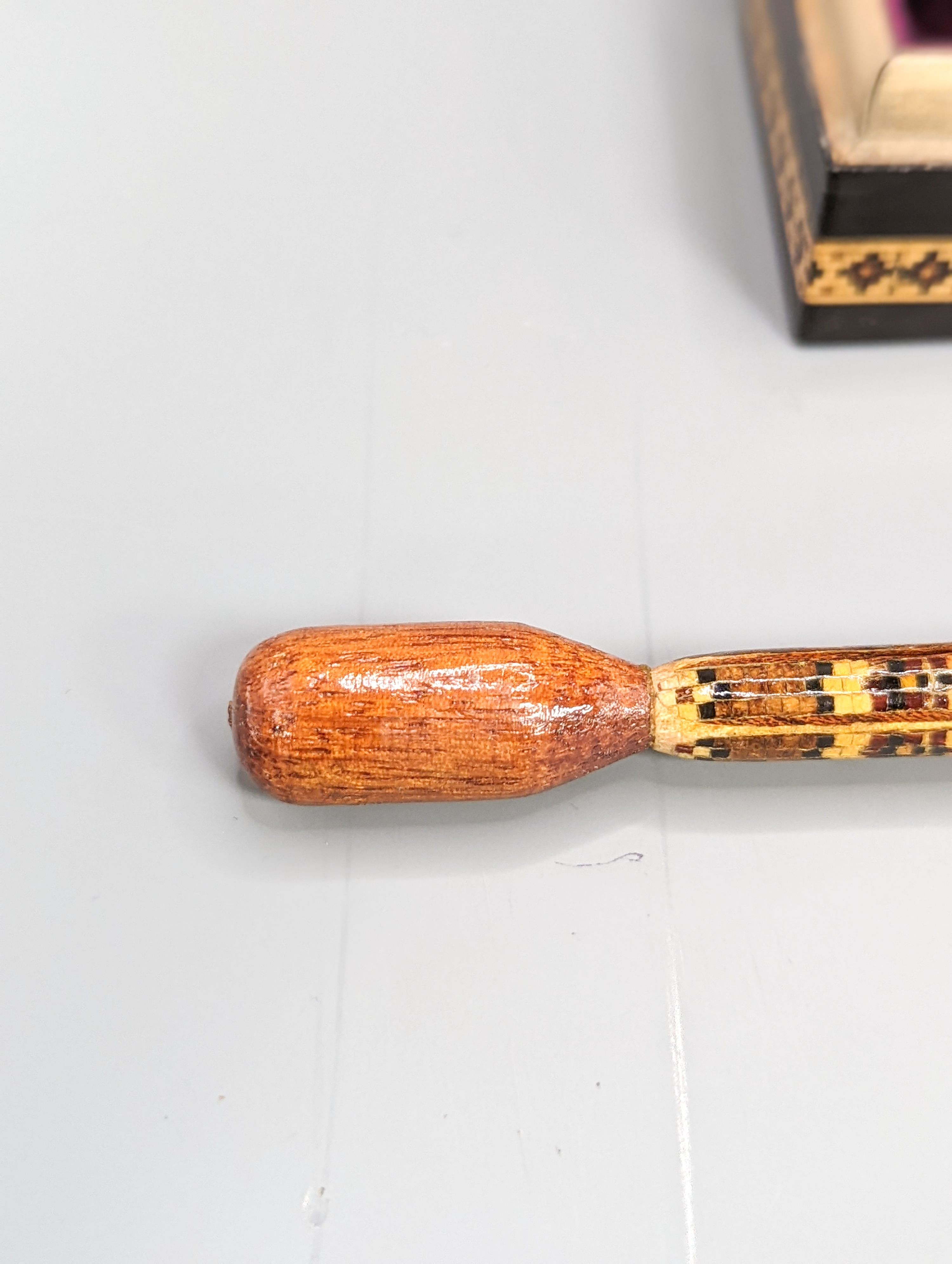 A Victorian Tunbridge ware ebony ground 'dog' ring box, width 9cm, and a stickware glove stretcher